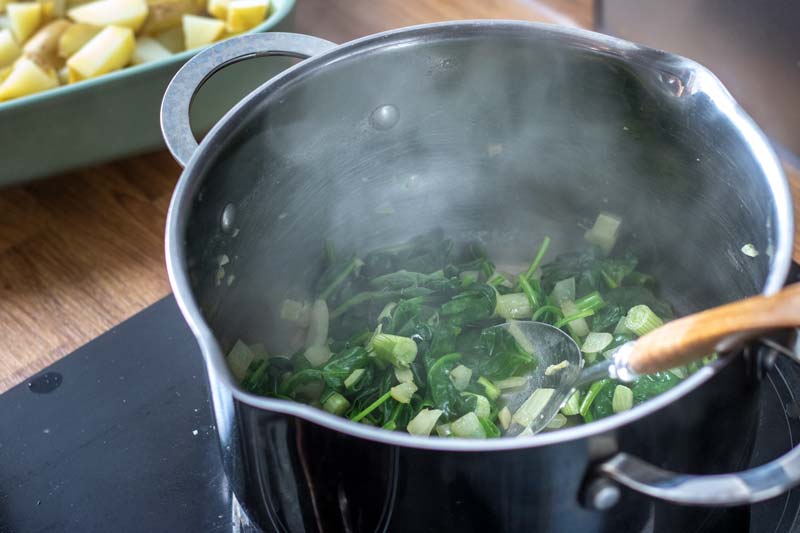 Spinach and other ingredients in pan