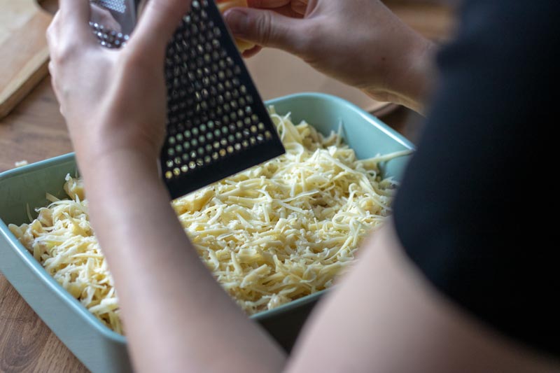 cheese being grated on top