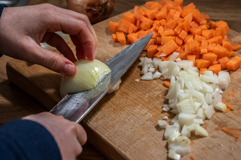 Onion being diced next to diced carrot